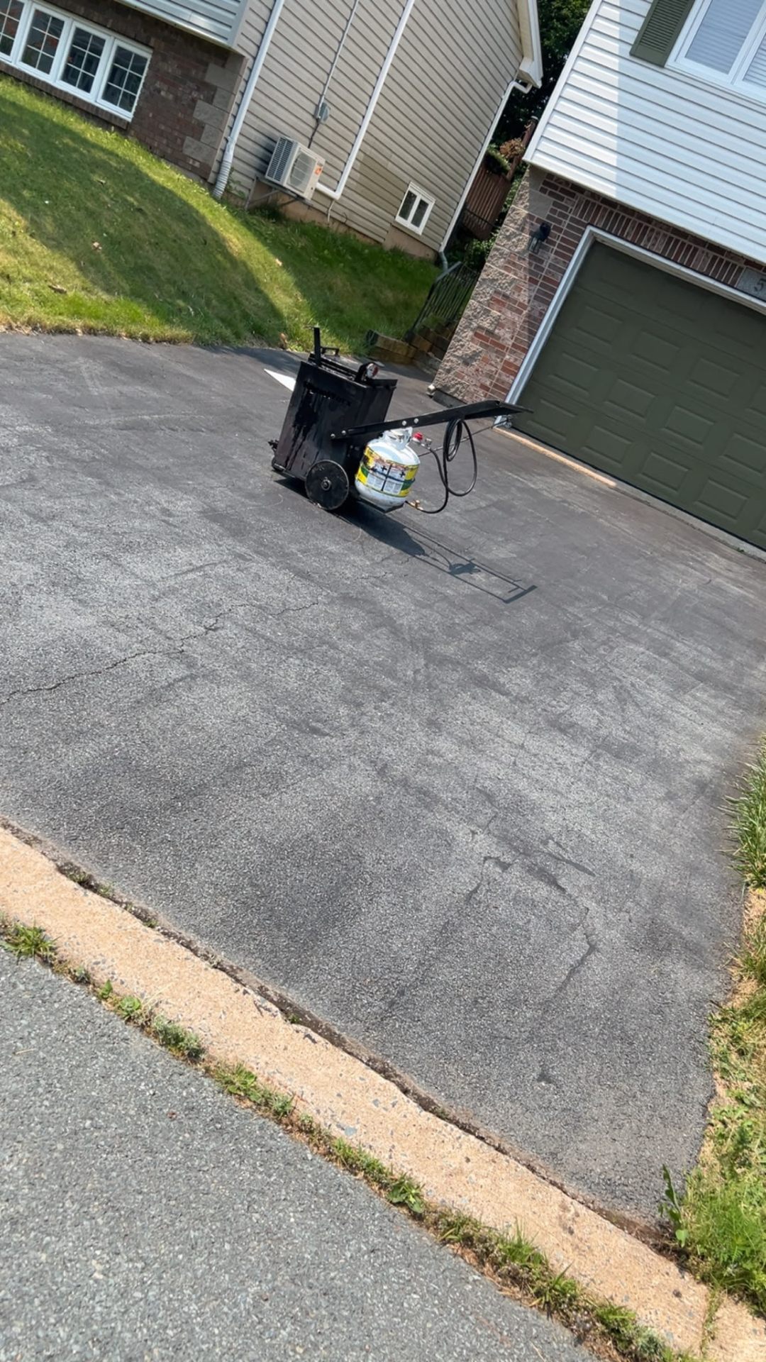 Before — residential driveway crack repair, HRM